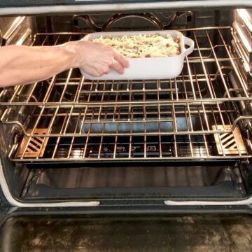Placing cabbage casserole in the oven.