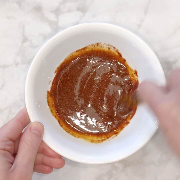 Seasoning mix for drumsticks is being mixed.