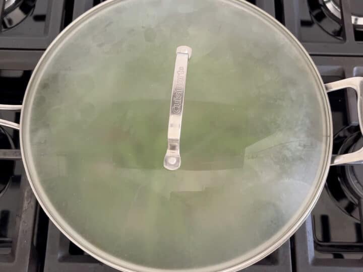 The skillet is covered with a lid.