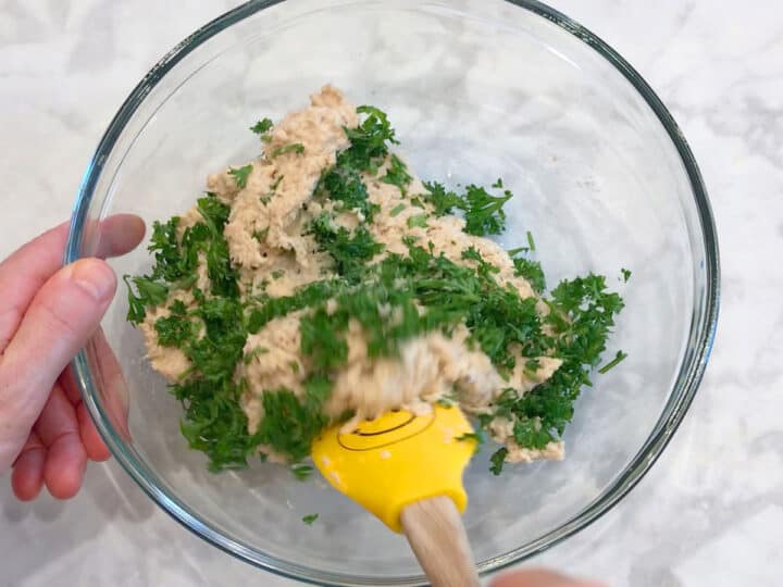 Adding parsley to the mixture.