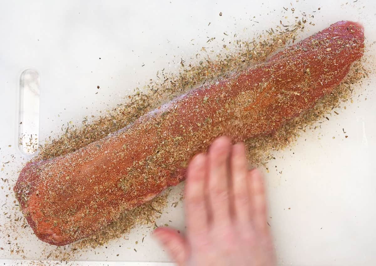 Coating the tenderloin with the spices. 