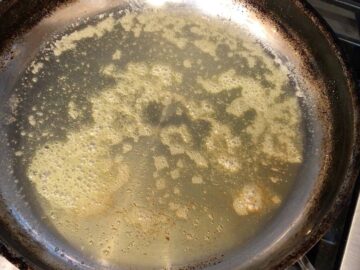 Melting butter in a skillet.