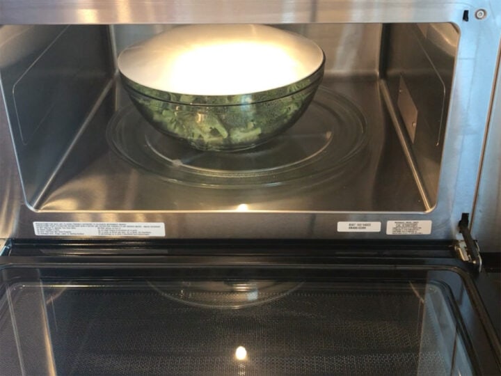 Microwaving broccoli florets.