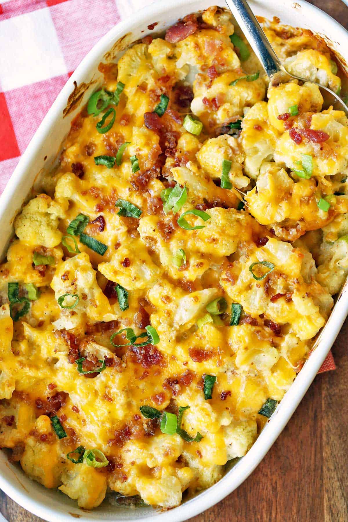 Cauliflower casserole topped with cheese and bacon.