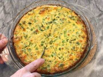 Cutting crustless broccoli quiche.