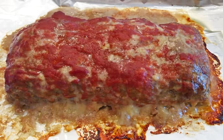 Fully cooked meatloaf on a baking sheet.