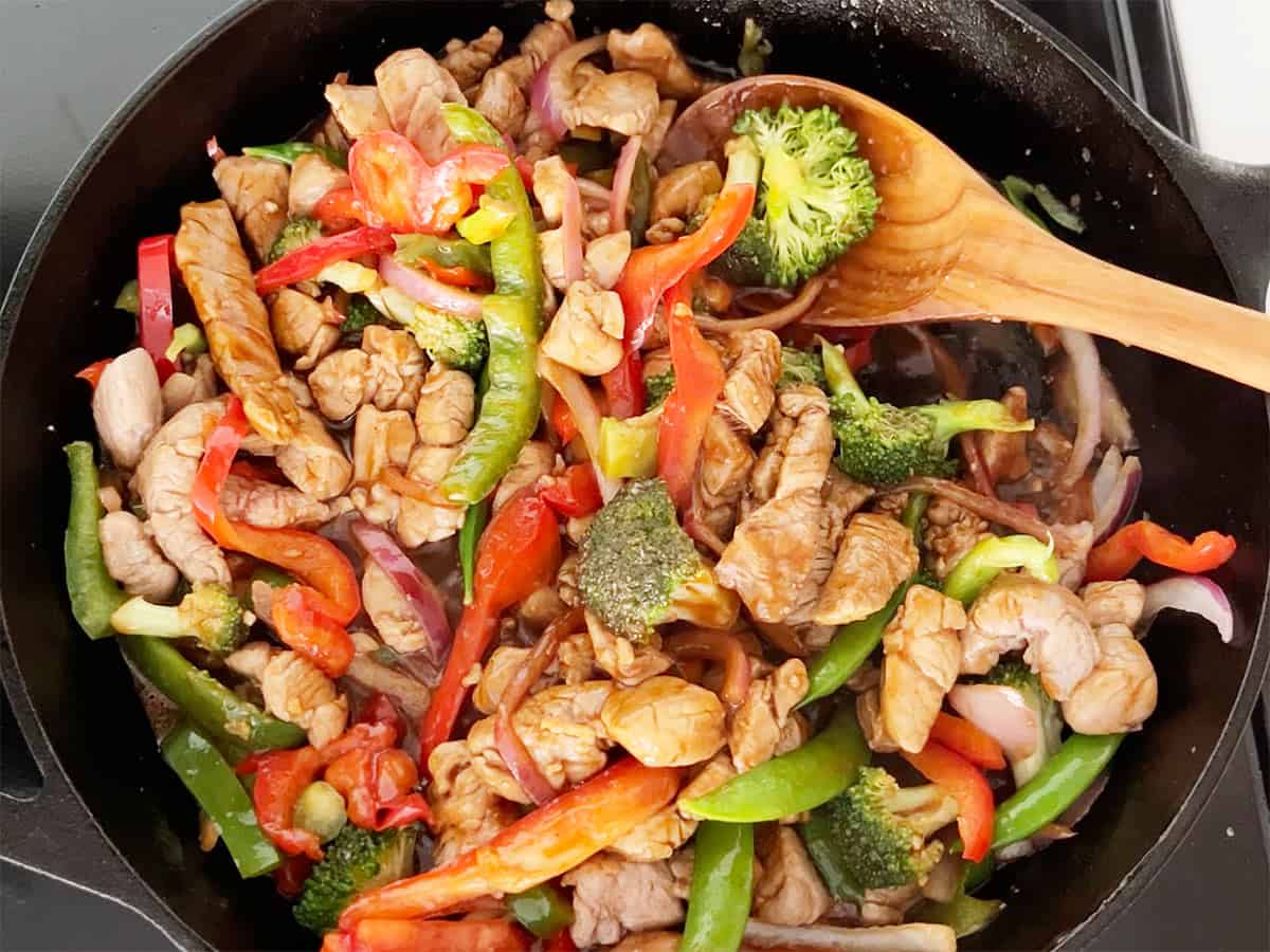 The stir fry is ready in the skillet.