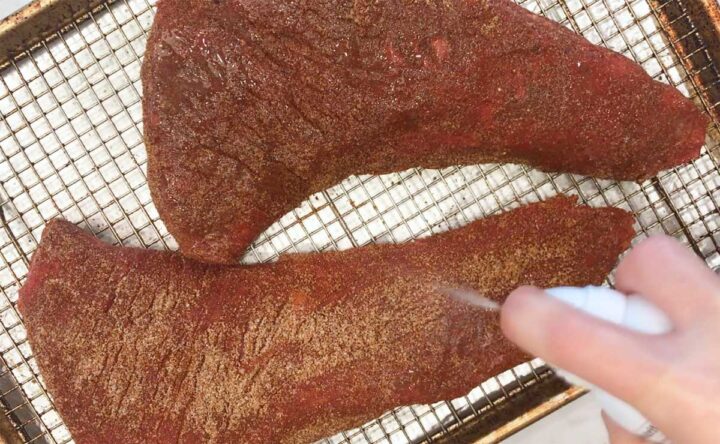 Spraying the tri-tip with oil.