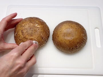 Cleaning portobello mushrooms.