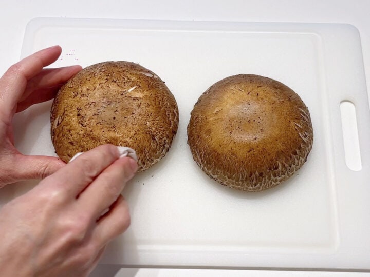 Cleaning portobello mushrooms.