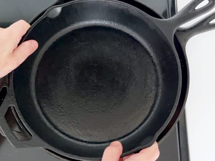 Placing a heavy skillet on top of the duck.