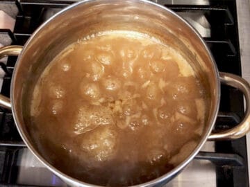 Reducing the cooking liquids on the stove.