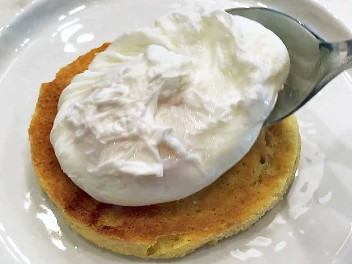 Serving the poached egg on toast.