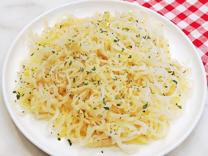 Shirataki noodles are served on a white plate.