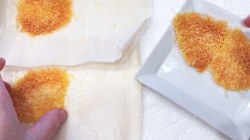 Removing cheese crackers from the parchment paper.