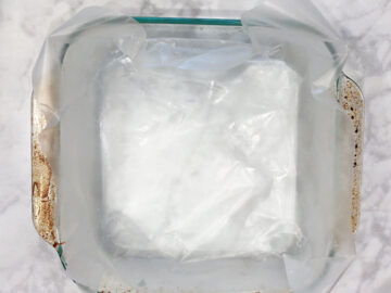 A baking dish with a wax paper overhang.