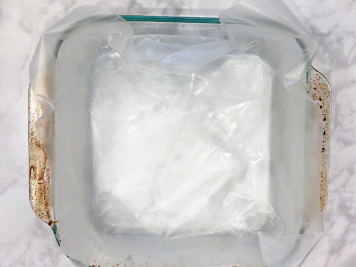 A baking dish with a wax paper overhang.