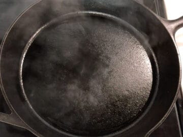 A smoking cast iron skillet.