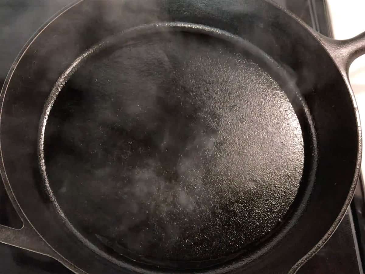 A smoking cast iron skillet.