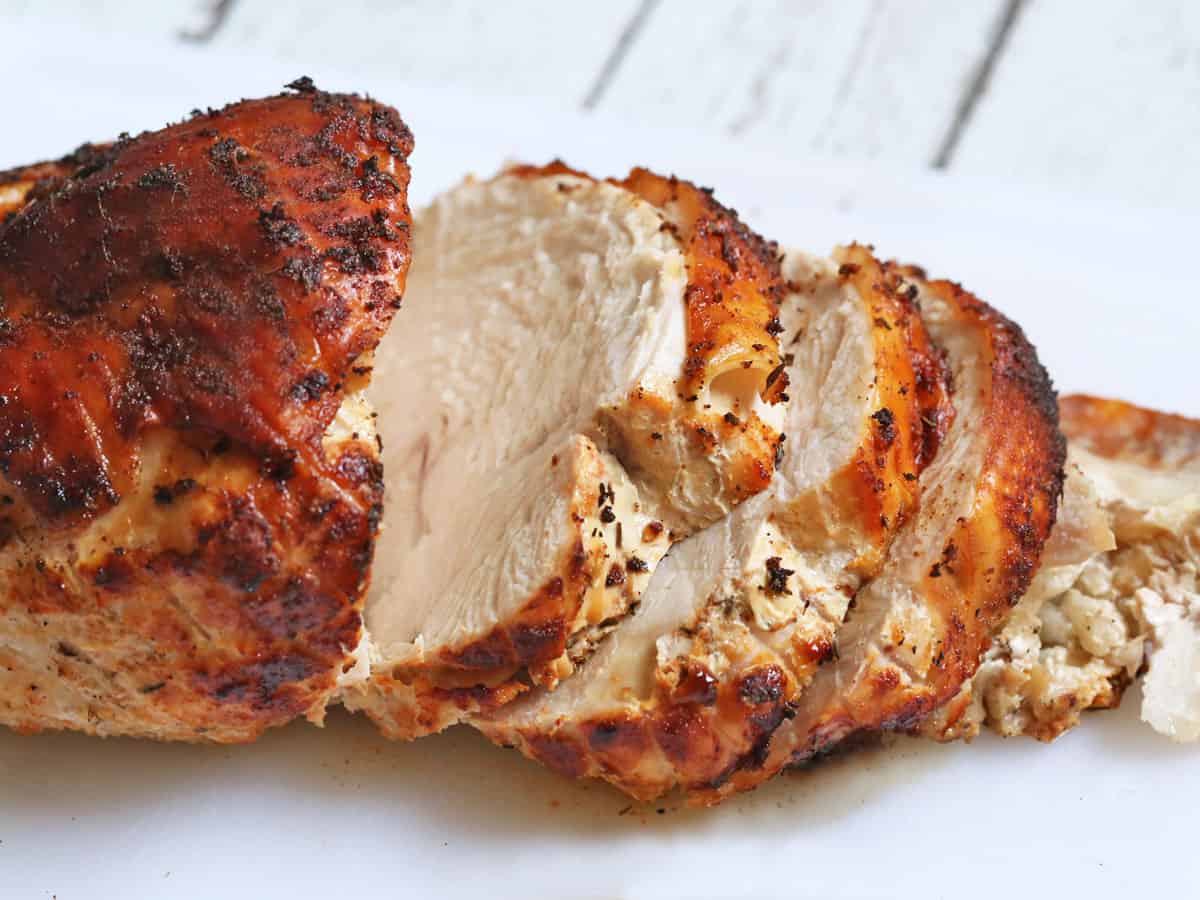 A fully cooked and sliced whole turkey breast.