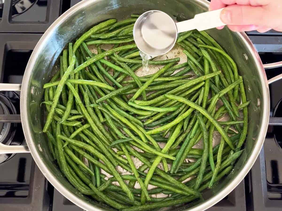 Adding water to the skillet.