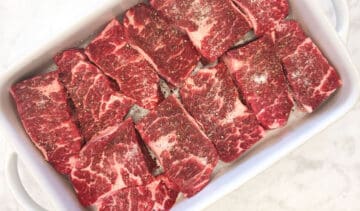 Boneless short ribs seasoned with salt and pepper.