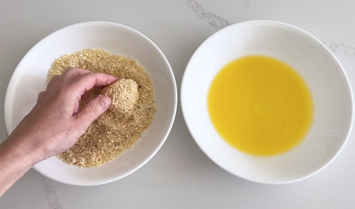Dredging a scallop in parmesan.