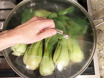 Covering the skillet with a lid.