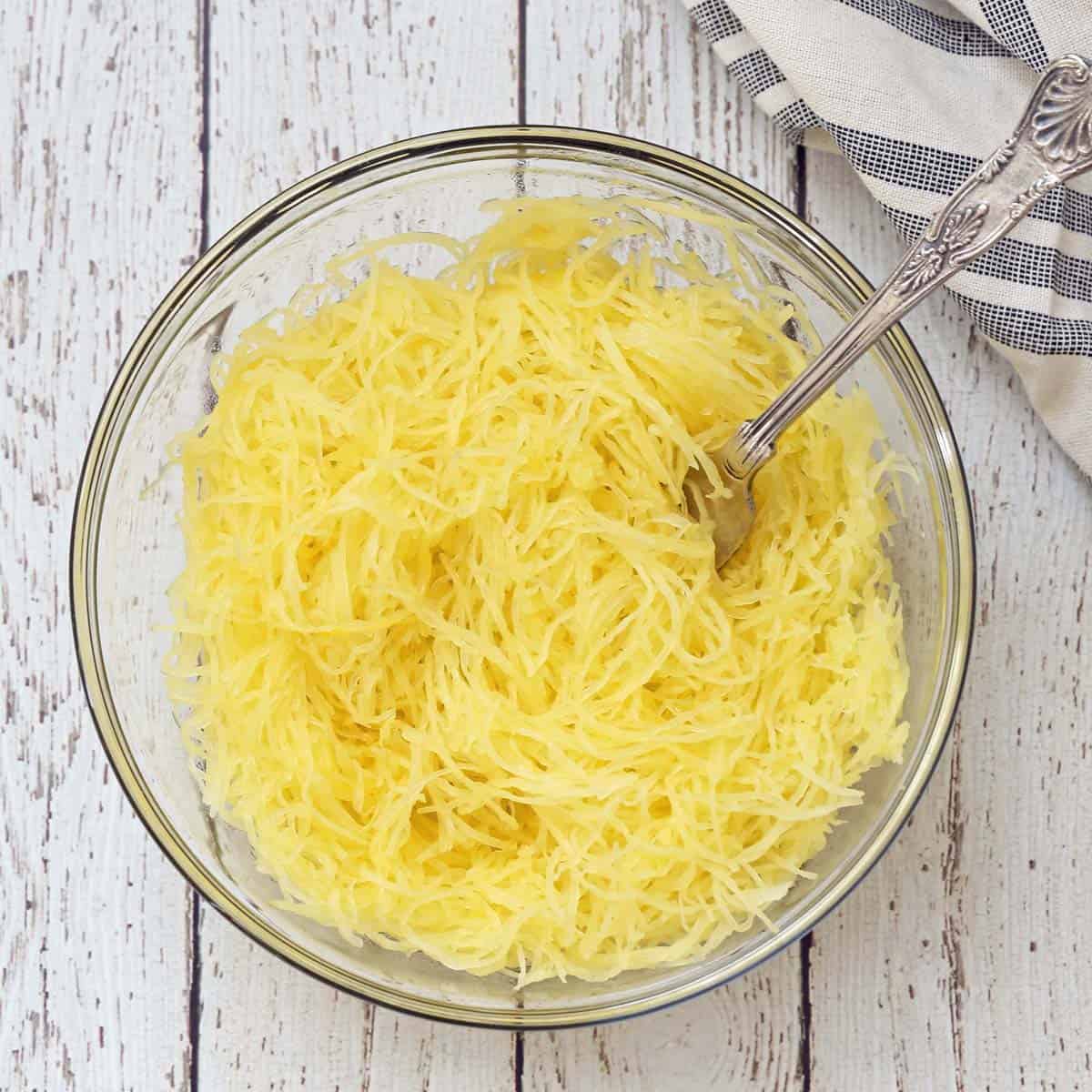 Spaghetti squash strands in a glass bowl.