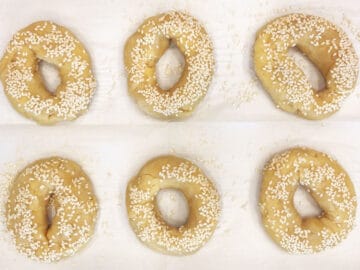 The bagels are on the baking sheet, ready for the oven.