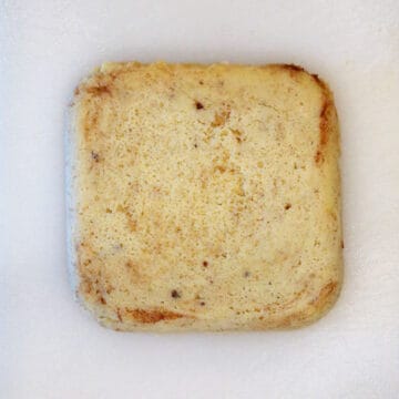 Placing the bread on a cutting board.