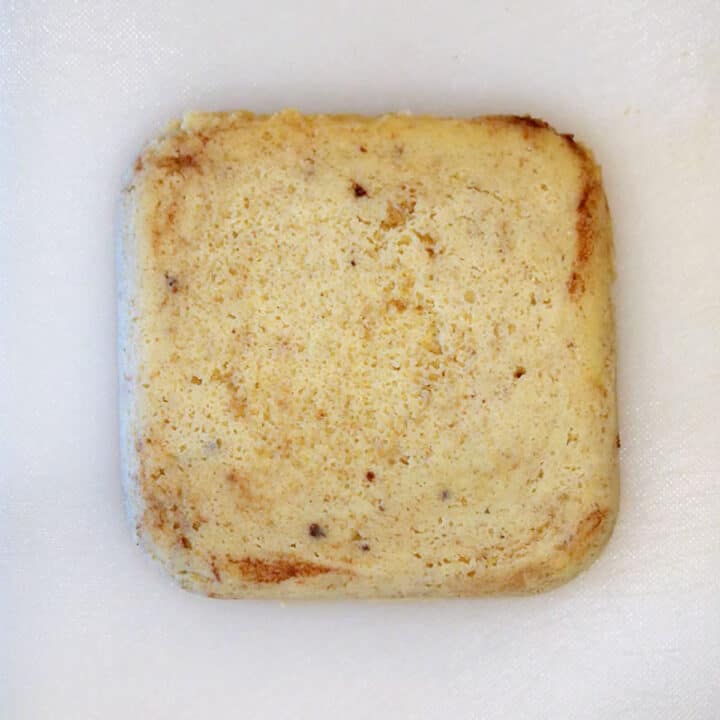 Placing the bread on a cutting board.