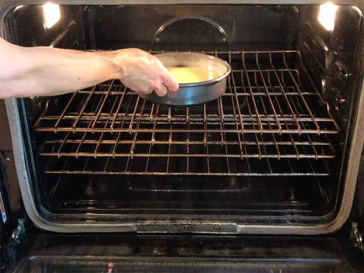 Placing the cake in the oven.