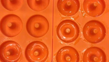 Grease the donut pan cavities.