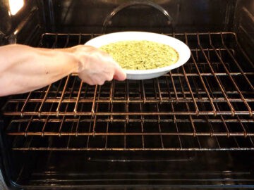 Placing the quiche in the oven.
