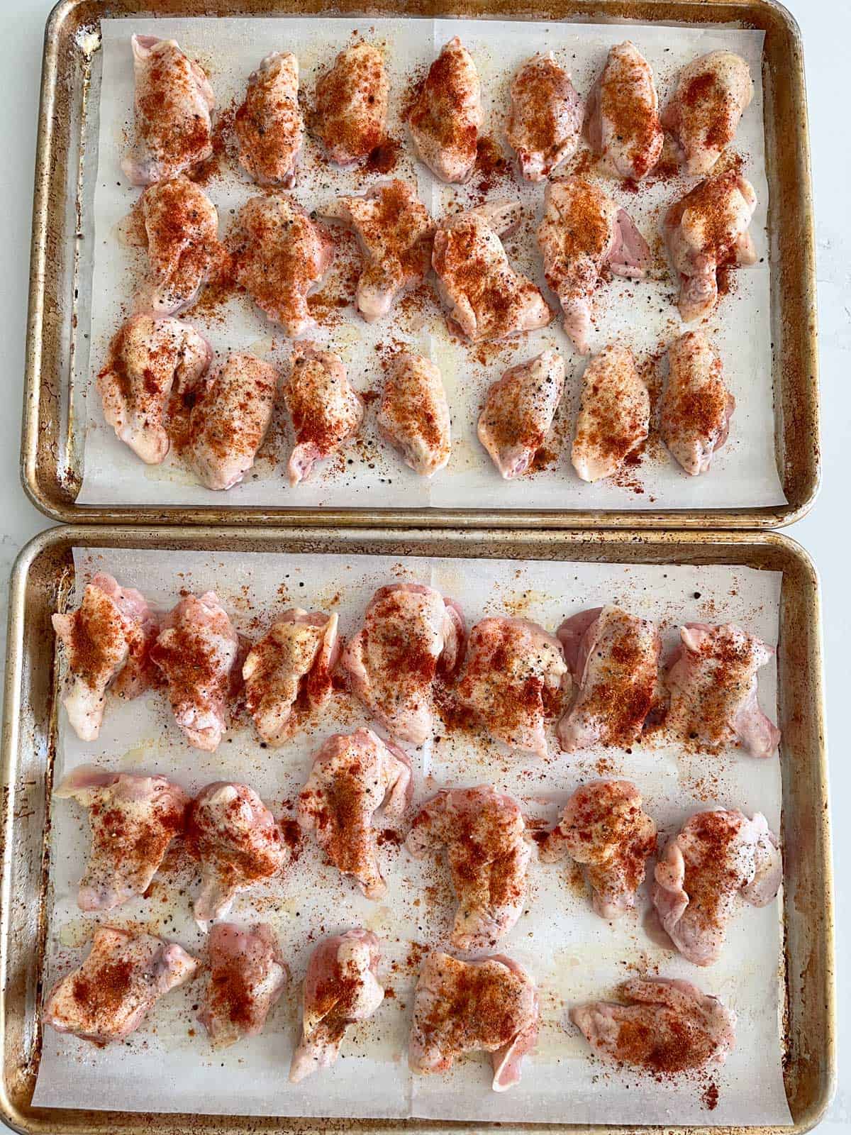 The raw wings are seasoned and ready for the oven.