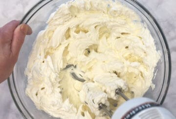 Whipping the cream cheese.