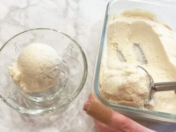 Scooping frozen yogurt into a bowl.