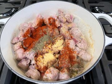 Adding spices to the stew.