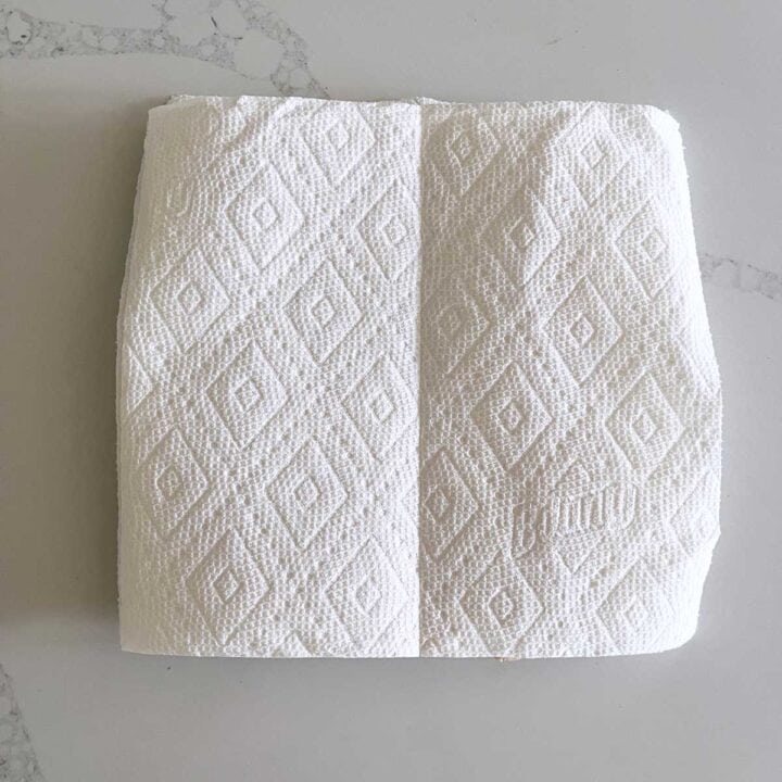 The bacon is covered with paper towels.