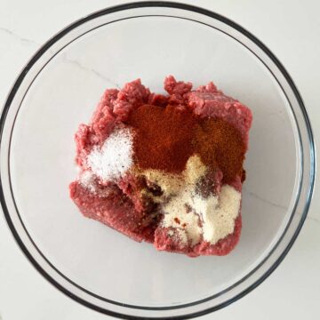 Ground beef and spices in a bowl.