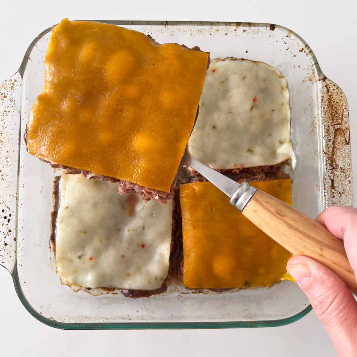 Lifting a square from the pan.