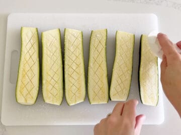 Wiping the water off the zucchini.