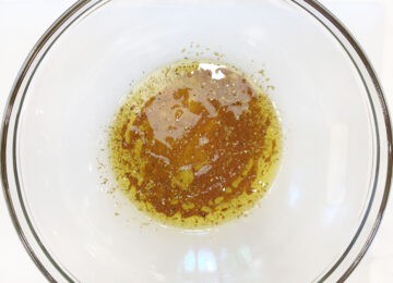 The marinade for veggie kabobs was mixed in a bowl.