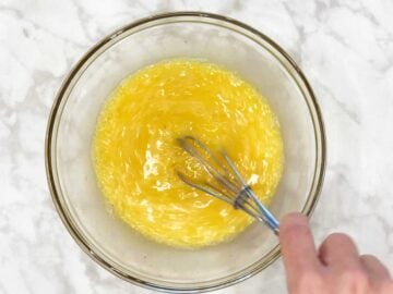 Whisking the eggs until fluffy.