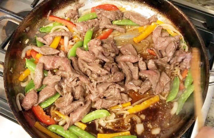 The sauce and beef strips were added to the skillet.