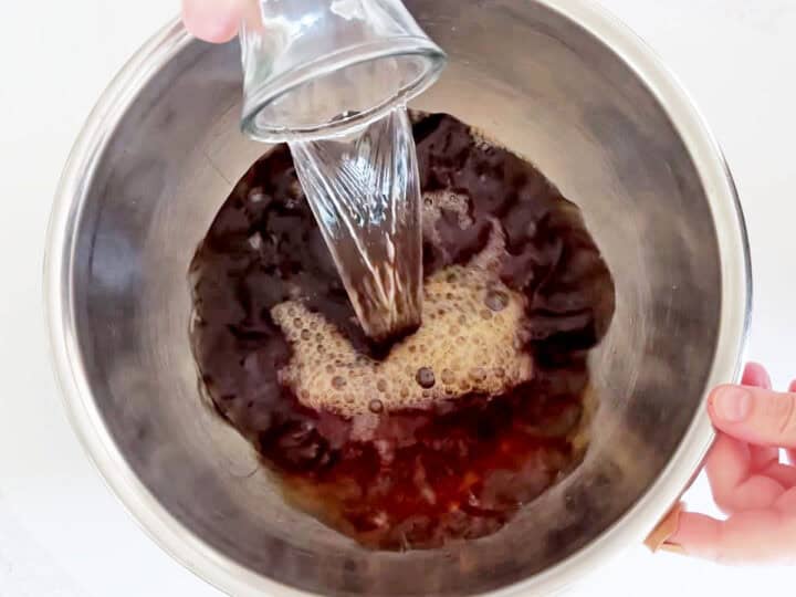 Adding water to the tea.