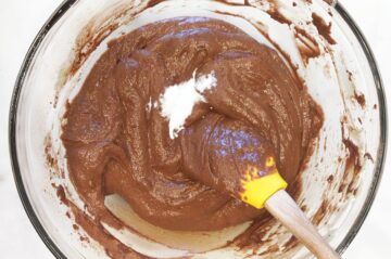 Adding baking soda to the batter.