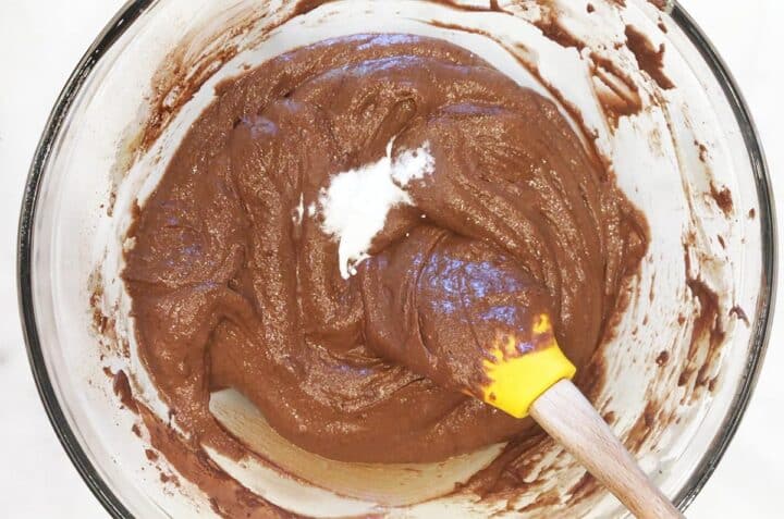 Adding baking soda to the batter.