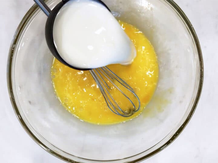 Adding milk to the batter.
